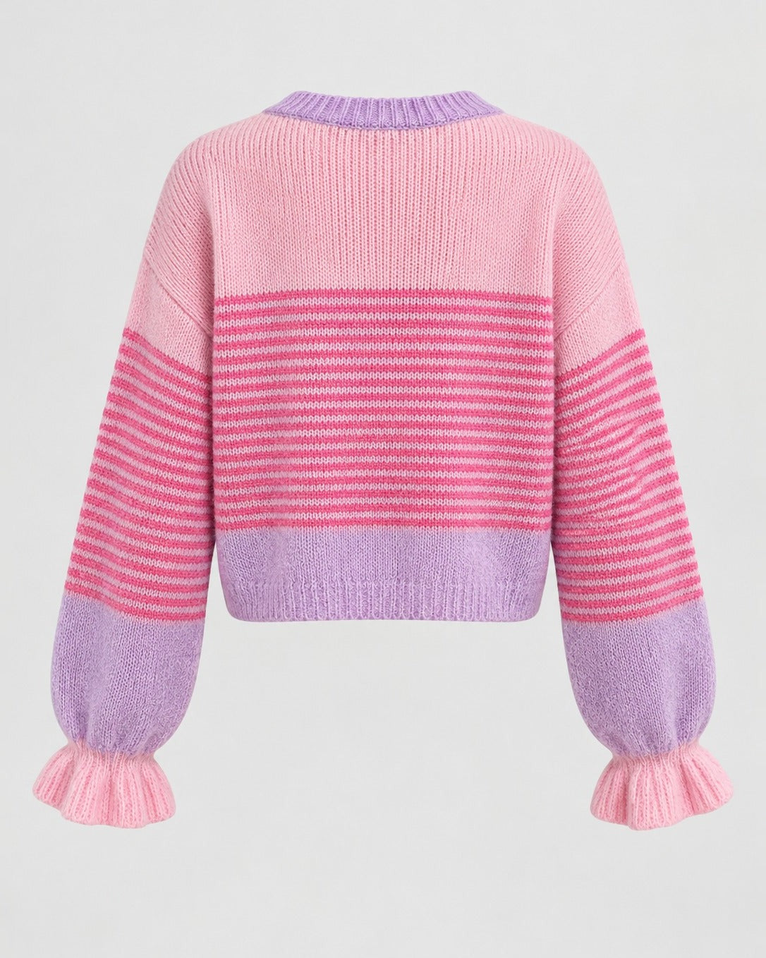 Detail of soft ruffle trim on fine-gauge knit cardigan placket