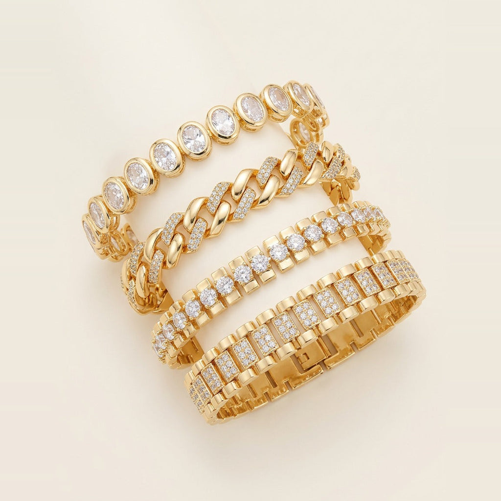 Four gold-toned link bracelets stacked on a wrist in Gold.