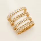 Four gold-toned link bracelets stacked on a wrist in Gold.