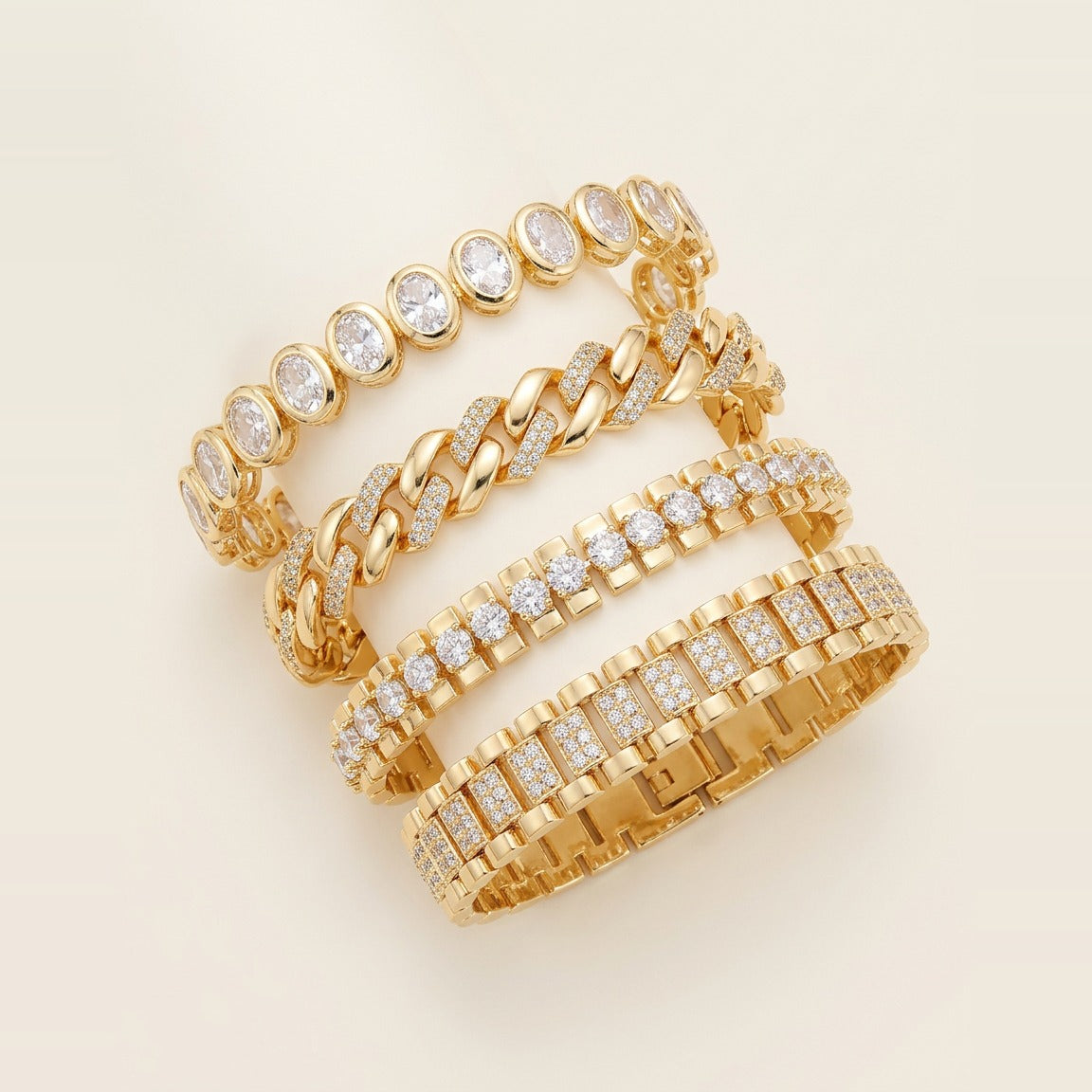 Four gold-toned link bracelets stacked on a wrist in Gold.