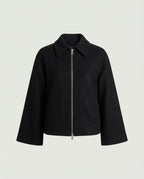 Model wearing the Structured Wide Sleeve Zip Jacket in Black, shown zipped up.