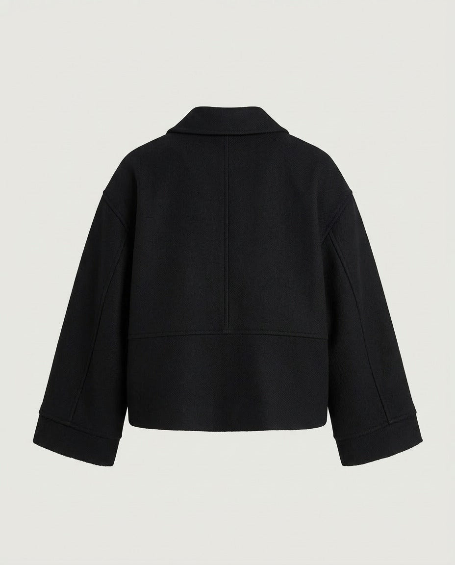 The loose silhouette of the Structured Wide Sleeve Zip Jacket in Black.