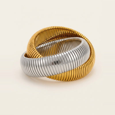 Interlocking tubogas bracelet in silver on a white surface.