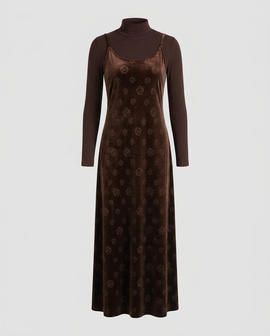 Black velvet midi slip dress with thin straps worn over a long-sleeve top.