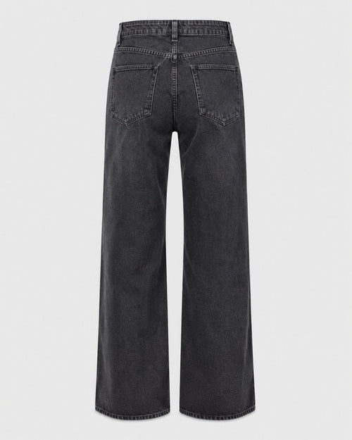 Rigid blue denim wide leg jeans showing straight full-length silhouette