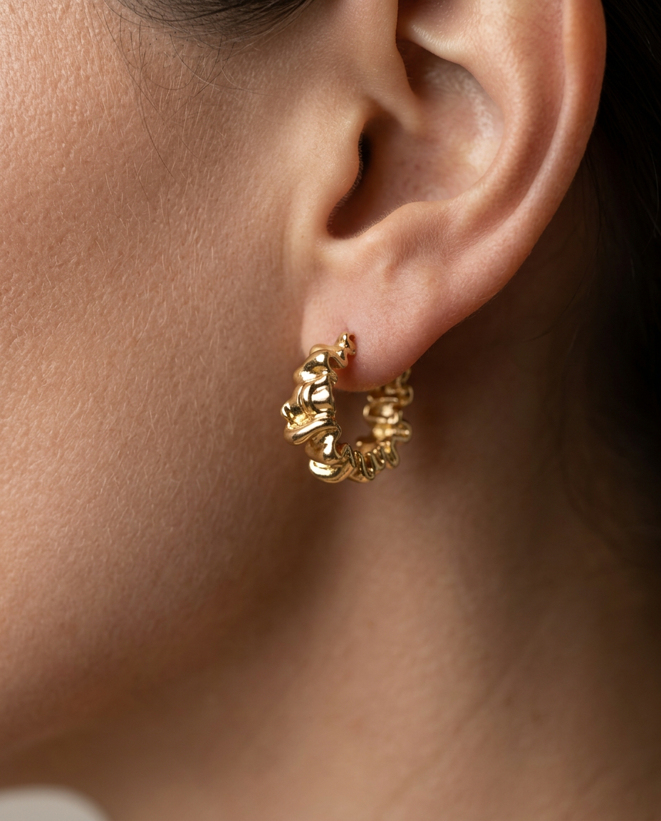 Sculptural Wavy Hoop Earring in Gold worn on the ear